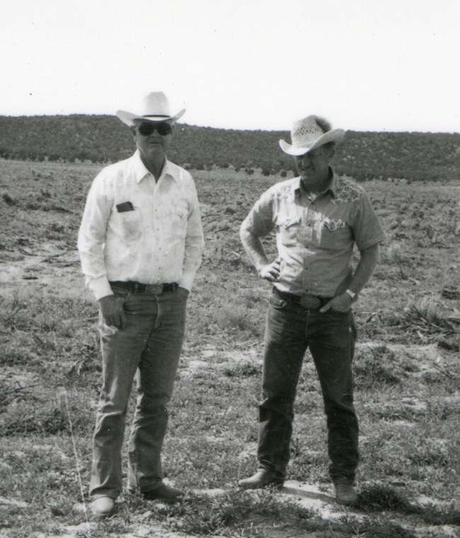 Black and white photo of two male ranchers.