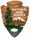 Symbol of the National Park Service in the shape of an arrowhead.