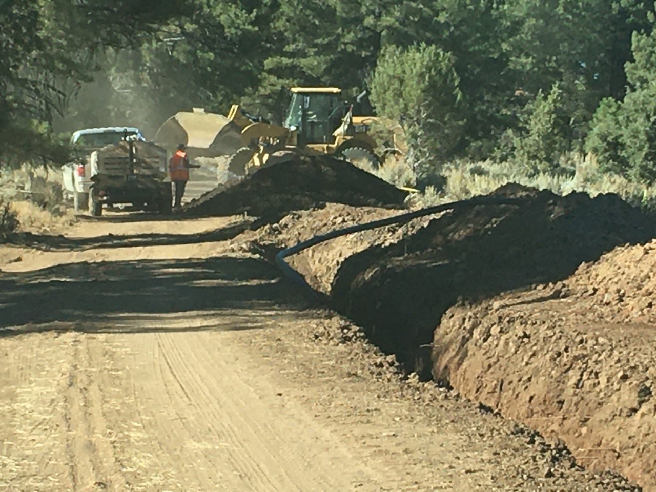 Road under construction with four foot deep trench along the road