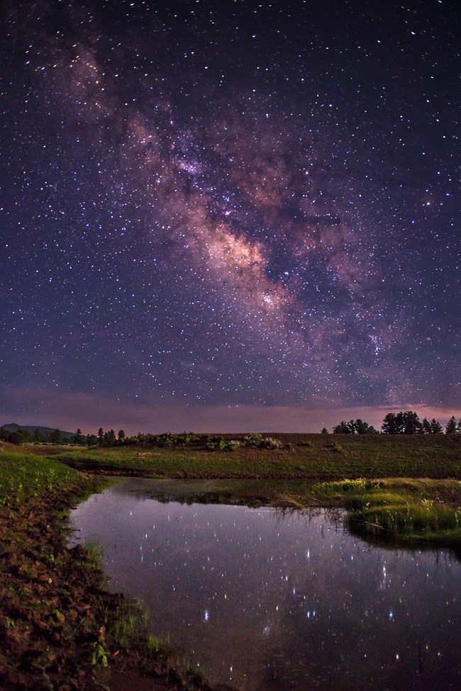 Oak Grove Tank A star lit watering hole with the milk way overhead.