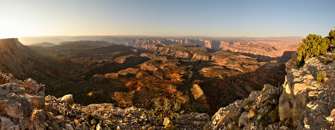 View of the Grand Canyon at sunrise. Many canyons and mesas span the landscape.