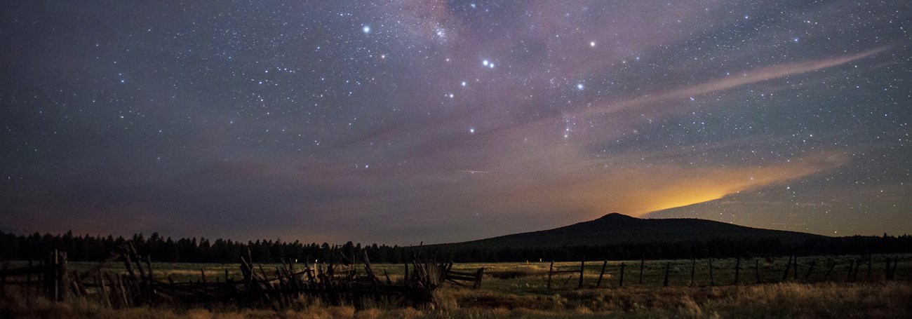 View of the starry night sky and Milky Way over Mount Dellenbaugh.