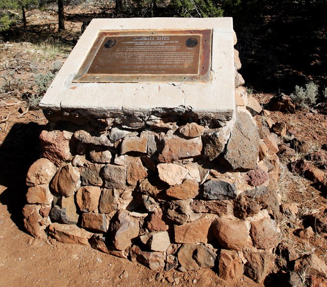 stone memorial along road