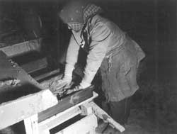 Evacuee making adobe brick