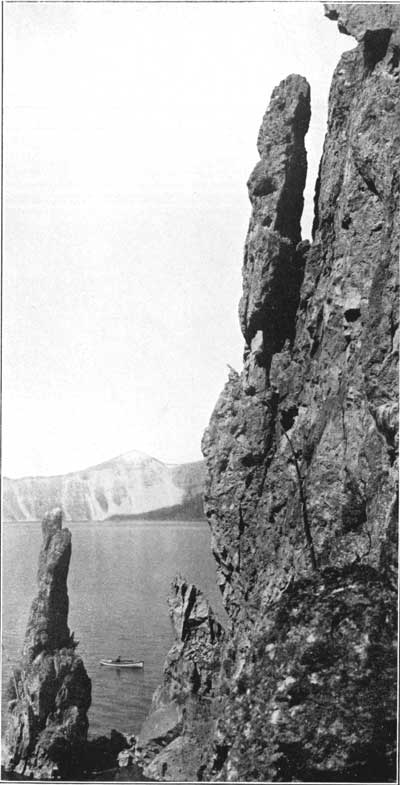 shore cliff with boat on lake in background