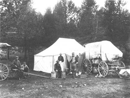 men in front of tents