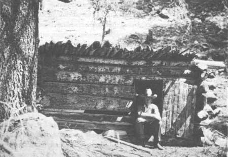 Peterson in doorway of cabin