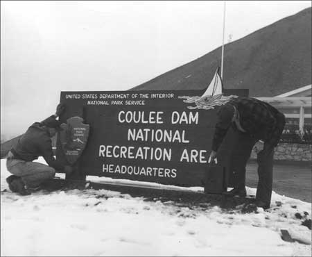 employees installing new headquarters sign