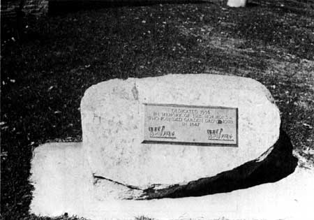 dedication marker on stone