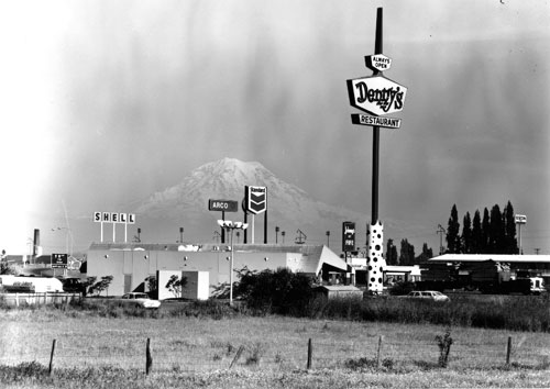 The cityscape encroaching on Mount Rainier as seen from Fife