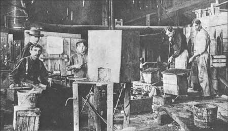 workers blowing glass