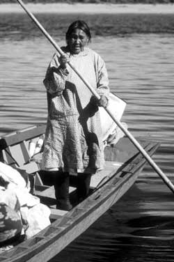 Inupiat woman poling a boat
