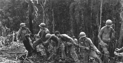 Soldiers and Marines consolidate their positions and construct barbed
wire obstacles