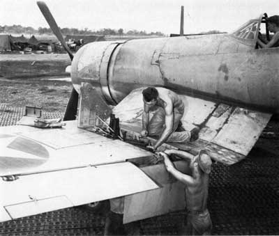 mechanics servicing F4U Corsair