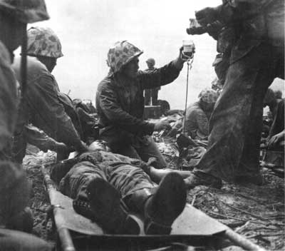 Navy corpsmen helping wounded