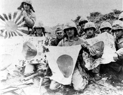 Marines holding captured Japanese flags