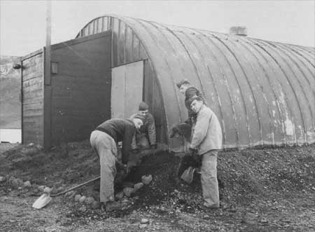 laying sod around base of Nissen hut