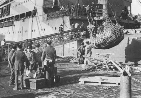 Marines loading gear on board a transport