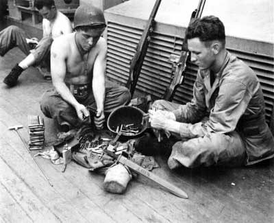 troops cleaning weapons