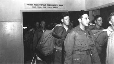 parachutists with sign overhead