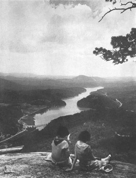 visitors at overlook with river below