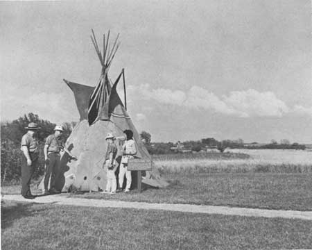 teepee with park rangers and park visitors