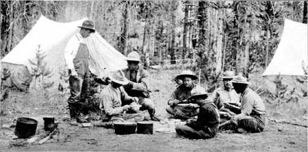 visitors around campfire