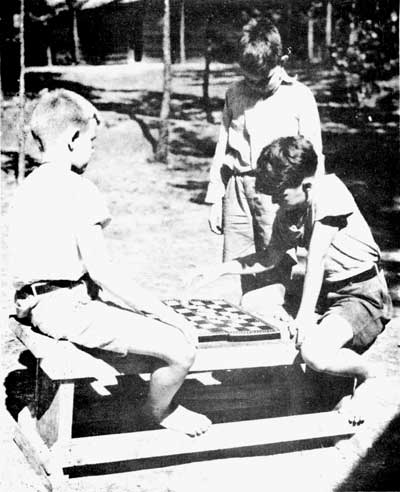 boys at cdamp playing checkers