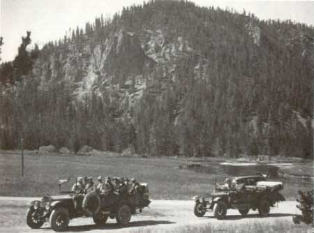 two vehicles passing National Park Mountain, Yellowstone NP