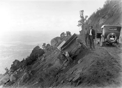 car precariously off the edge of road