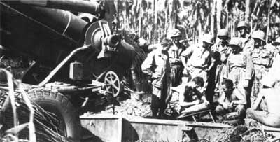 Soldiers from the 25th Infantry Division add graffiti to a shell