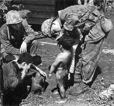 Marines bathe a tiny Tinian girl