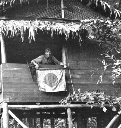 Marine displaying captured Japanese flag