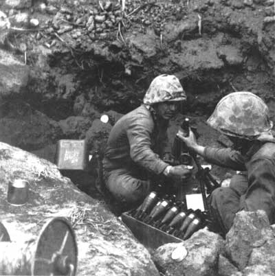 Marines firing mortar