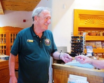 Park volunteer interacting with a visitor in the visitor center.