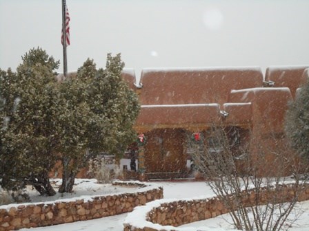 Large building with surrounding trees.