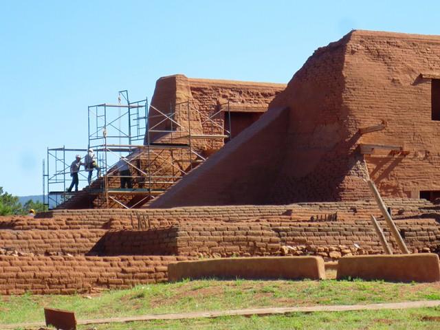 Workers on a scaffold working on a building.