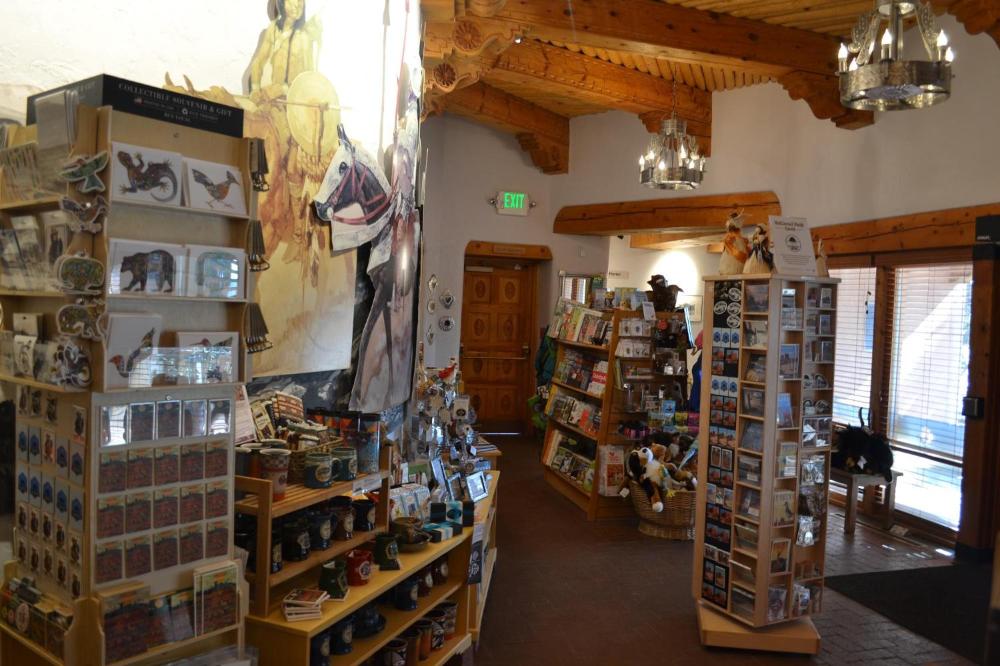 A couple shelves of books and other items sold in a bookstore.