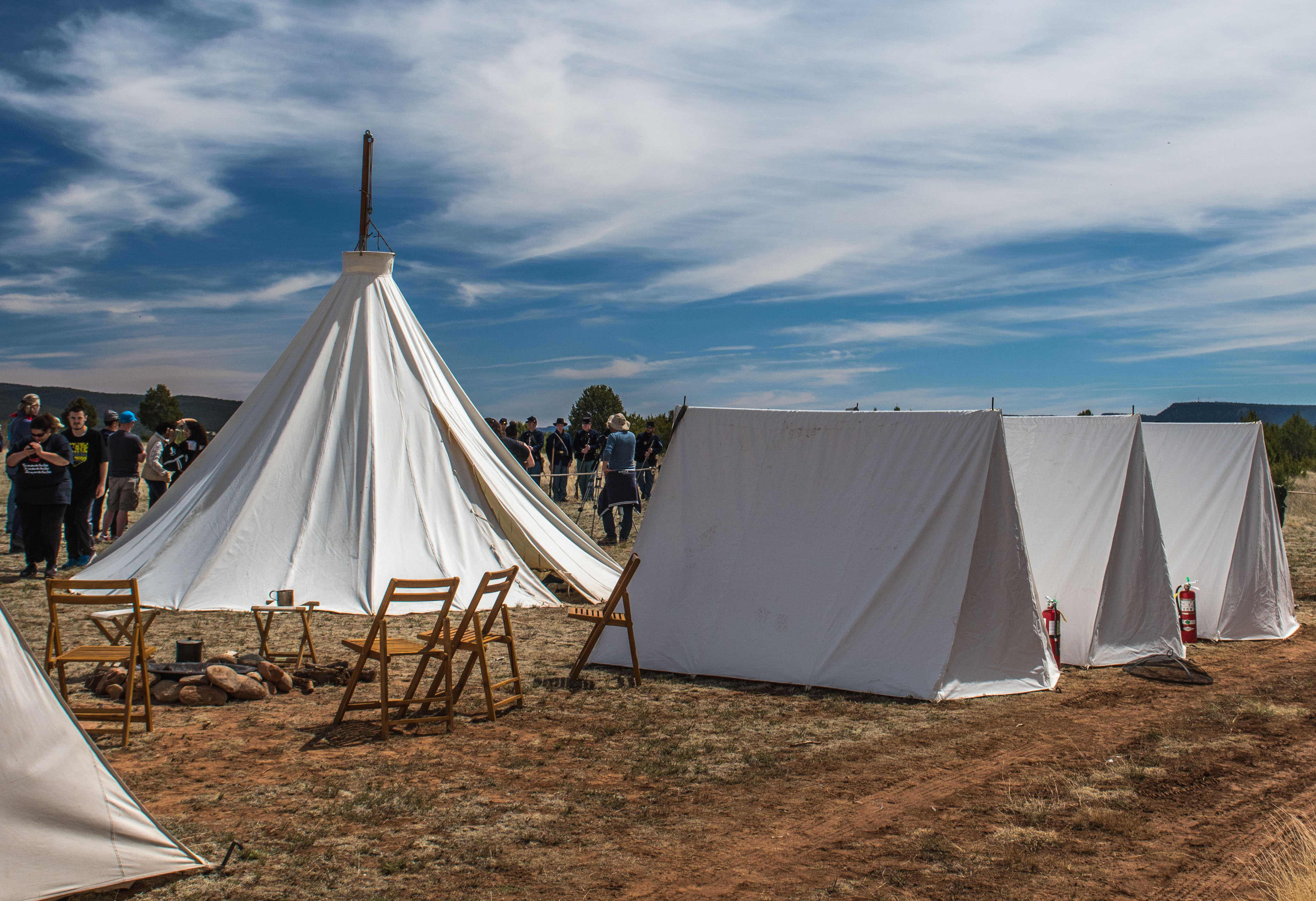 Tents at the Civil War Encampment at Pecos NHP. White tents on a dirt and grass field at the Civil War Encampment.