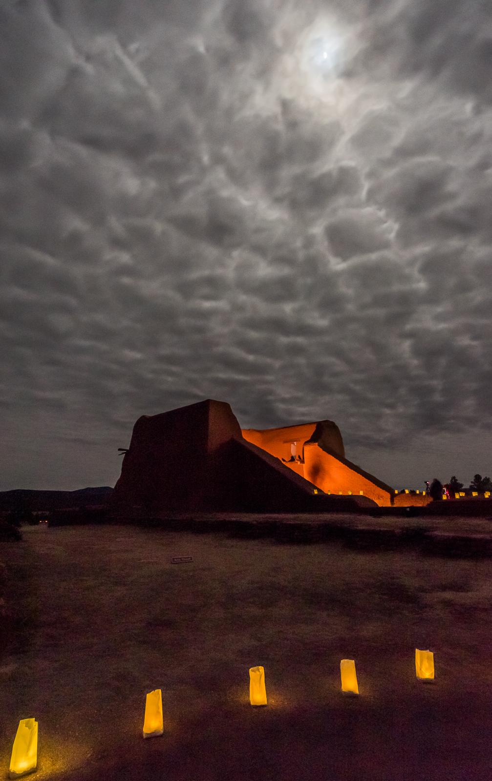 An old building with clouds in the background.