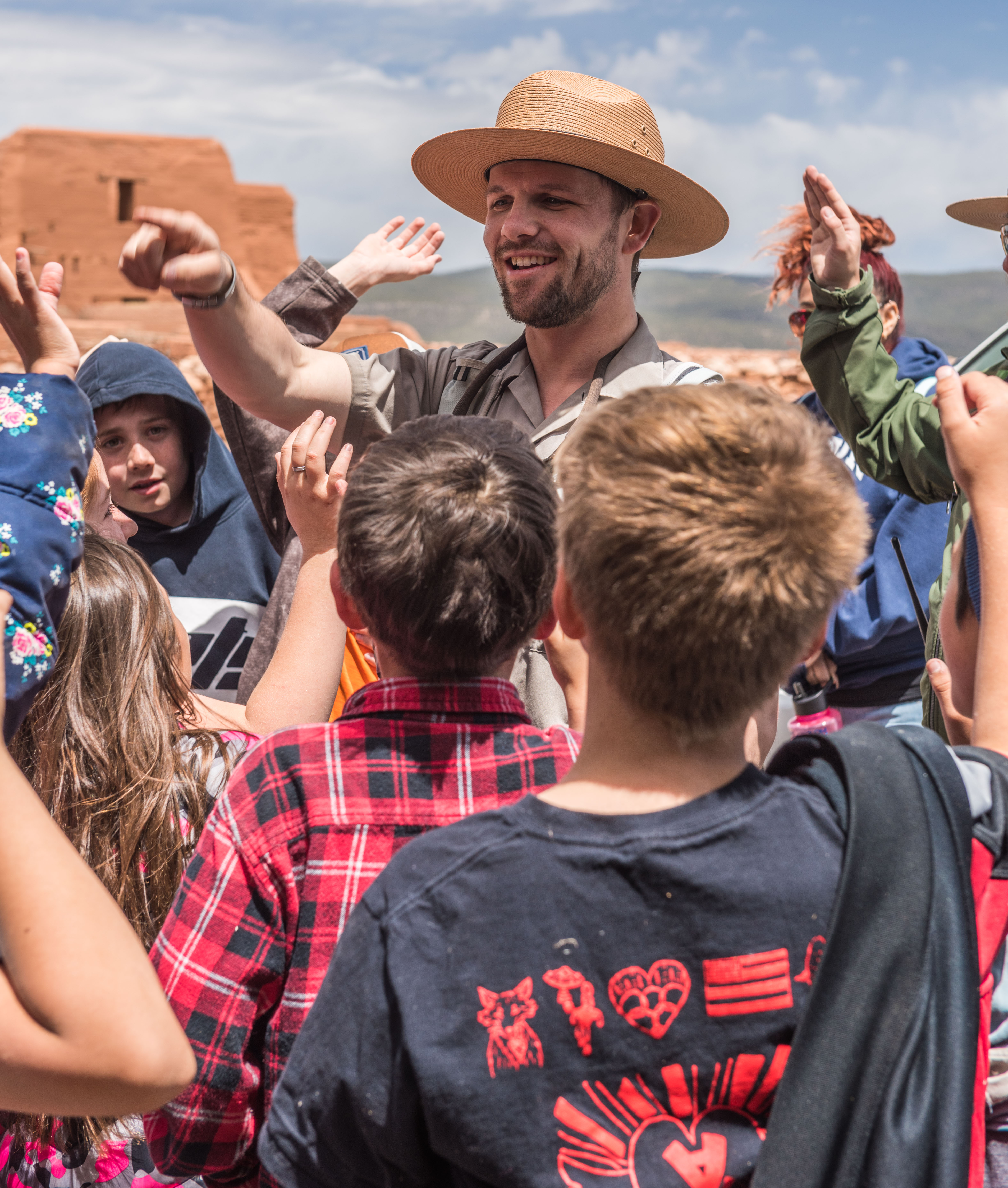 Kids gathered around a ranger during a field trip.