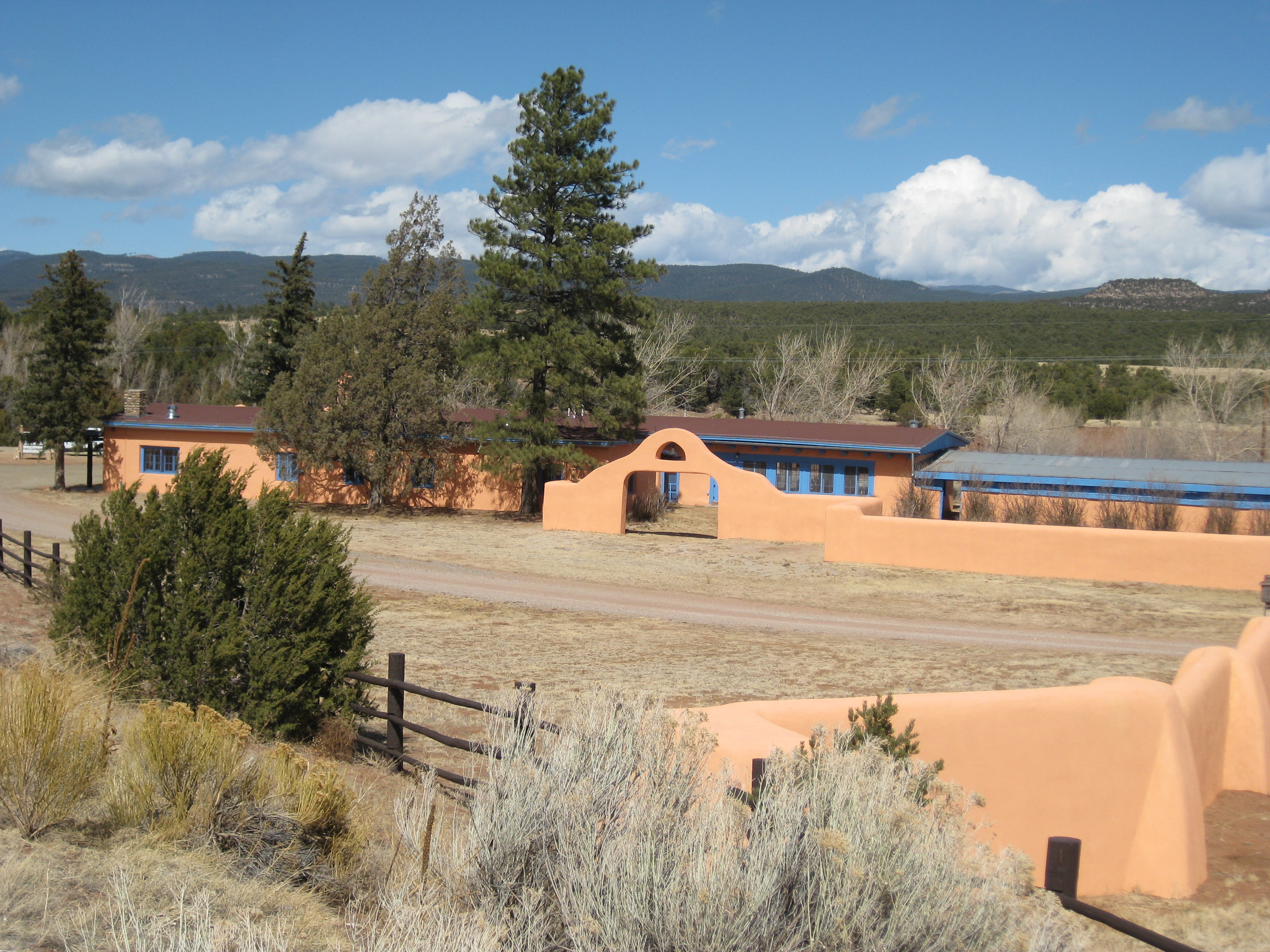 orange adobe building under a blue sky