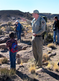 Park volunteer points out something to young visitor Park volunteer points out something to young visitor