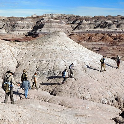 Hikers crossing badlands in the Red Basin area