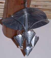 one of six hand-hammered tin light fixtures hangs from ceiling in lunch room