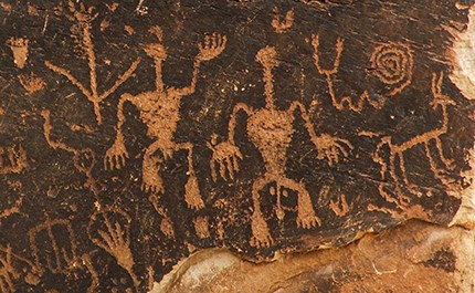 Petroglyph panel dominated by 2 human figures Petroglyph panel dominated by 2 human figures