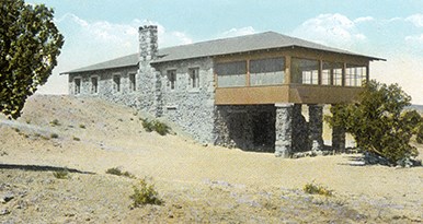postcard of stone building with large screened in porch