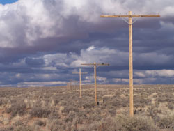 straight line of historic telephone poles under monsoon thunderheads straight line of historic telephone poles under monsoon thunderheads