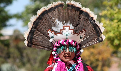 zuni dancer in elaborate feather headress