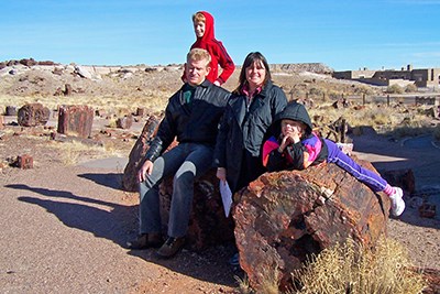 Family enjoying petrified wood along Giant Logs Trail